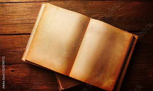 Open book on old wooden table