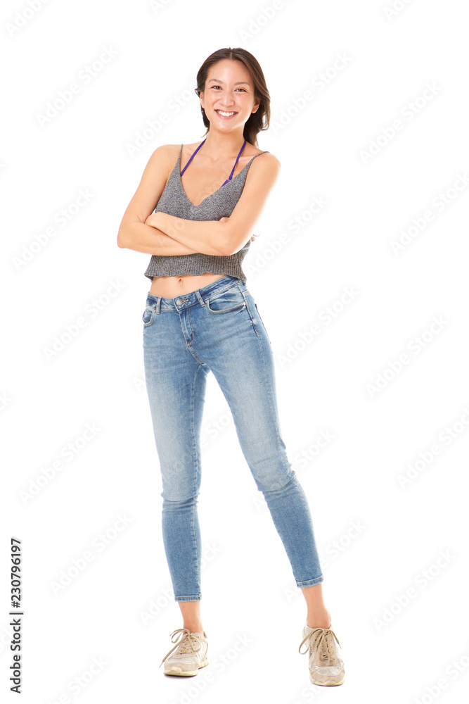 Full body happy young asian woman posing with arms crossed against isolated white background Full body happy young asian woman posing with arms crossed against isolated white background