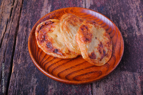 Obraz na płótnie Akok Kedut on wooden plate over the wooden table. Akok Kedut is a traditional dish in Malaysia especially East Coast. w salonie