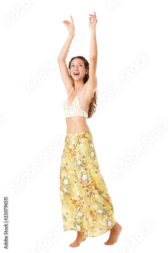 Happy young asian woman dancing against isolated white background