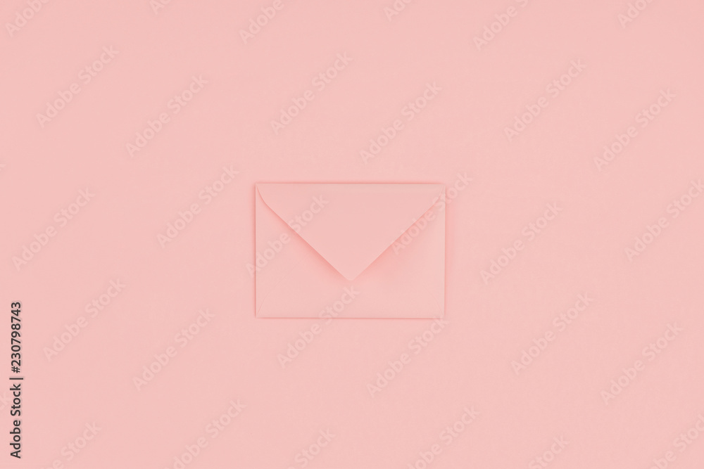 close-up view of single closed pink envelope isolated on pink