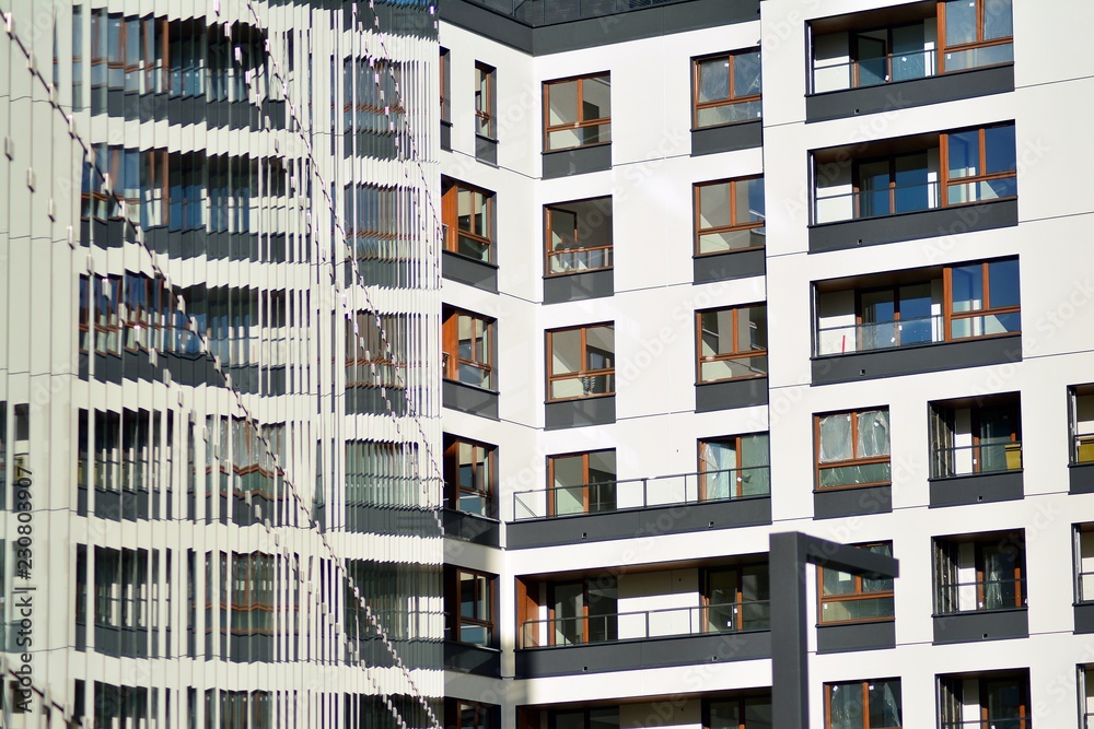 Modern apartment buildings on a sunny day with a blue sky. Facade of a modern apartment building