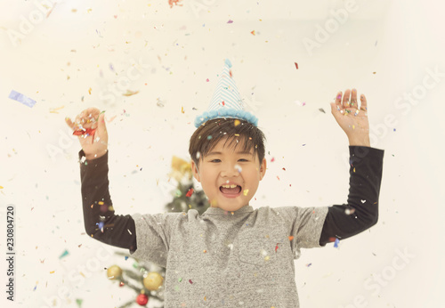 kid cheerful for celebrate with confetti christmas and happy new year party.