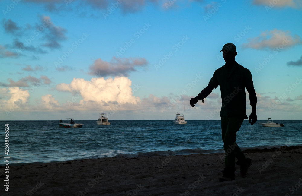 Person silhouette in the evening during sunset on the beach on Caribbean