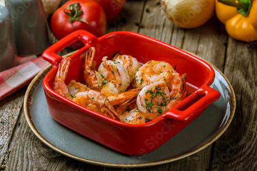 Tiger prawns fried in a red cast iron pan