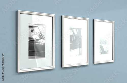 A sequence of three framed hanging pictures on a flat blue wall in a house with shiny wooden floors - 3D render