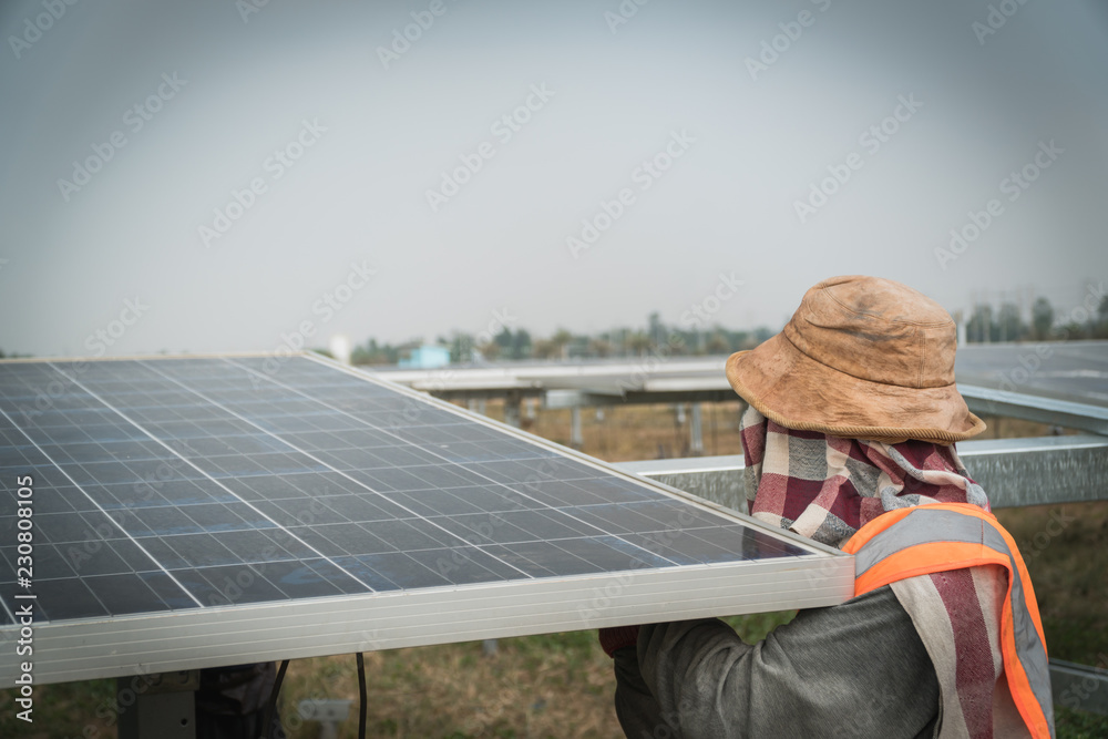 engineer and electrician installing solar power plant; scope of work at solar power plant tracking to sun