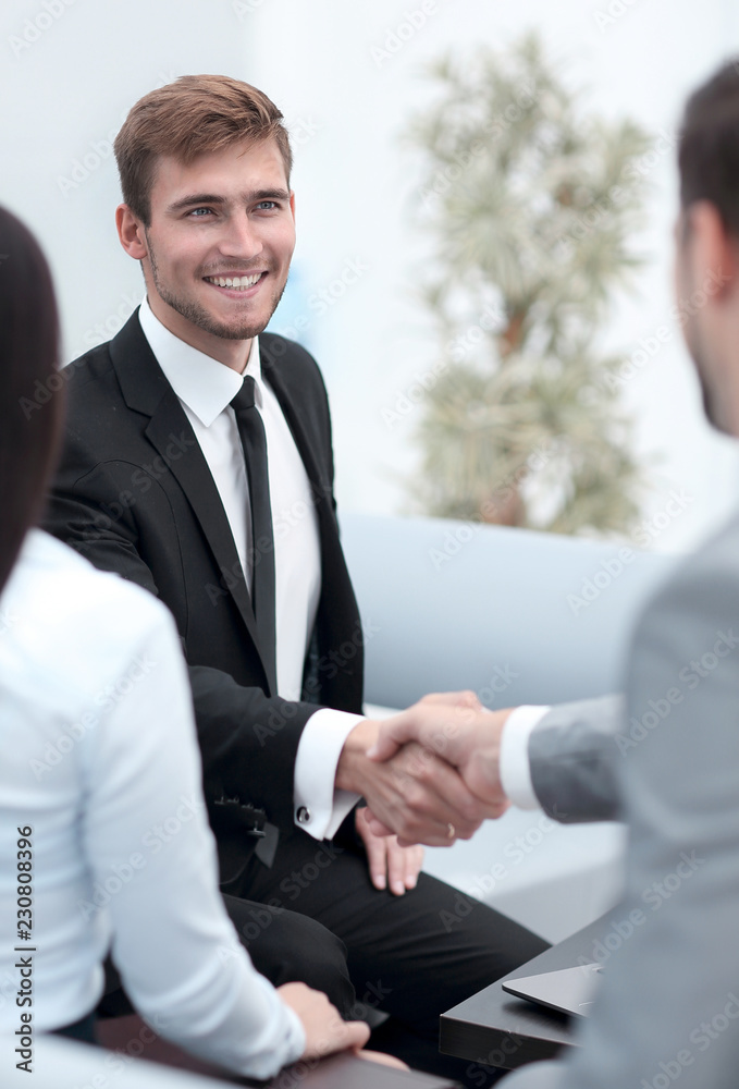 handshake business partners in the lobby of the office. handshake business partners in the lobby of the office.