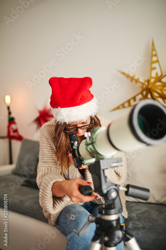 Christmas / New Year's joy with astronomy telescope and cujte girl.