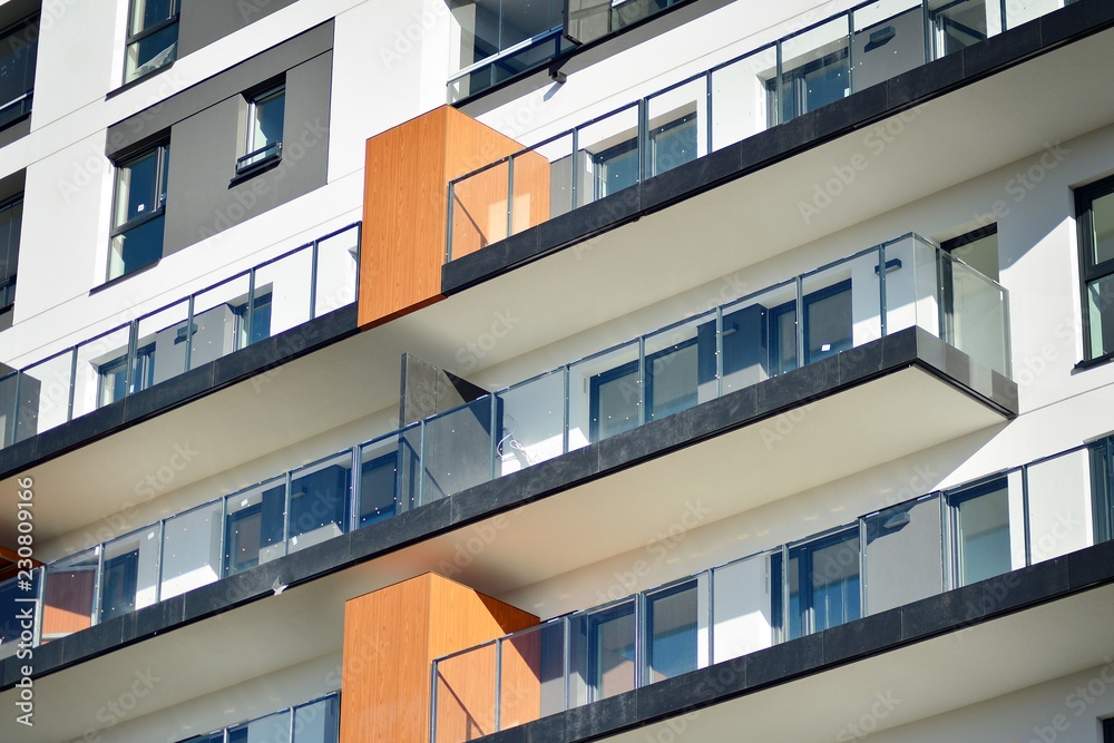 Modern apartment buildings on a sunny day with a blue sky. Facade of a modern apartment building Modern apartment buildings on a sunny day with a blue sky. Facade of a modern apartment building