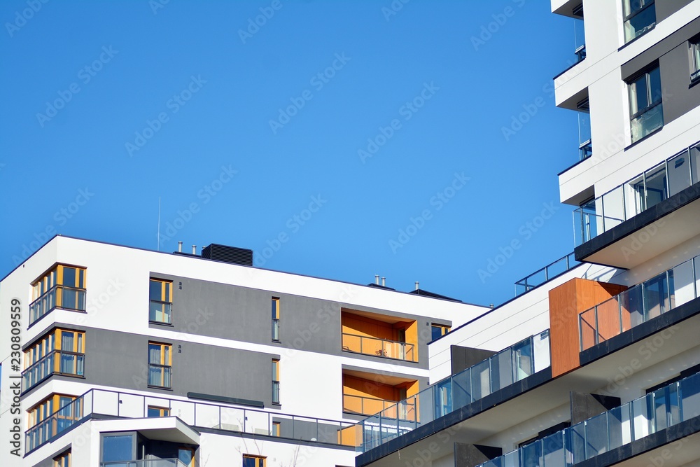 Modern apartment buildings on a sunny day with a blue sky. Facade of a modern apartment building Modern apartment buildings on a sunny day with a blue sky. Facade of a modern apartment building