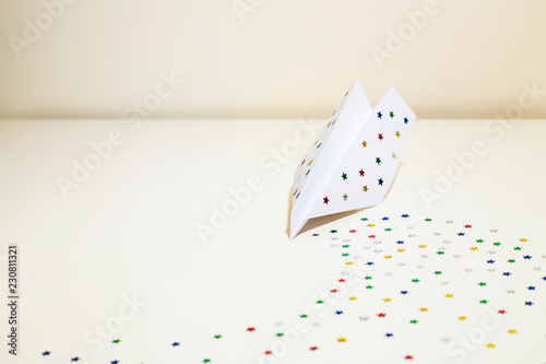 Paper airplane with sparkling stars