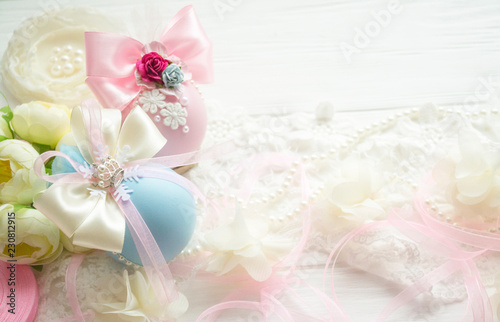 Fototapeta Naklejka Na Ścianę i Meble -  winter vacation. New Year's toys made by hand. Christmas balls of pink, blue color with a bow of satin ribbon, lace, pearls, flowers lies on a white wooden background
