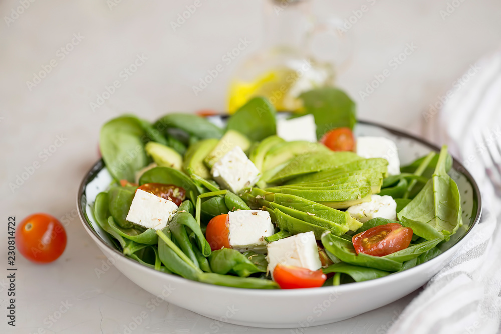 Healthy salad with spinach, avocado,tomatoes, feta cheese bowl Healthy salad with spinach, avocado,tomatoes, feta cheese bowl