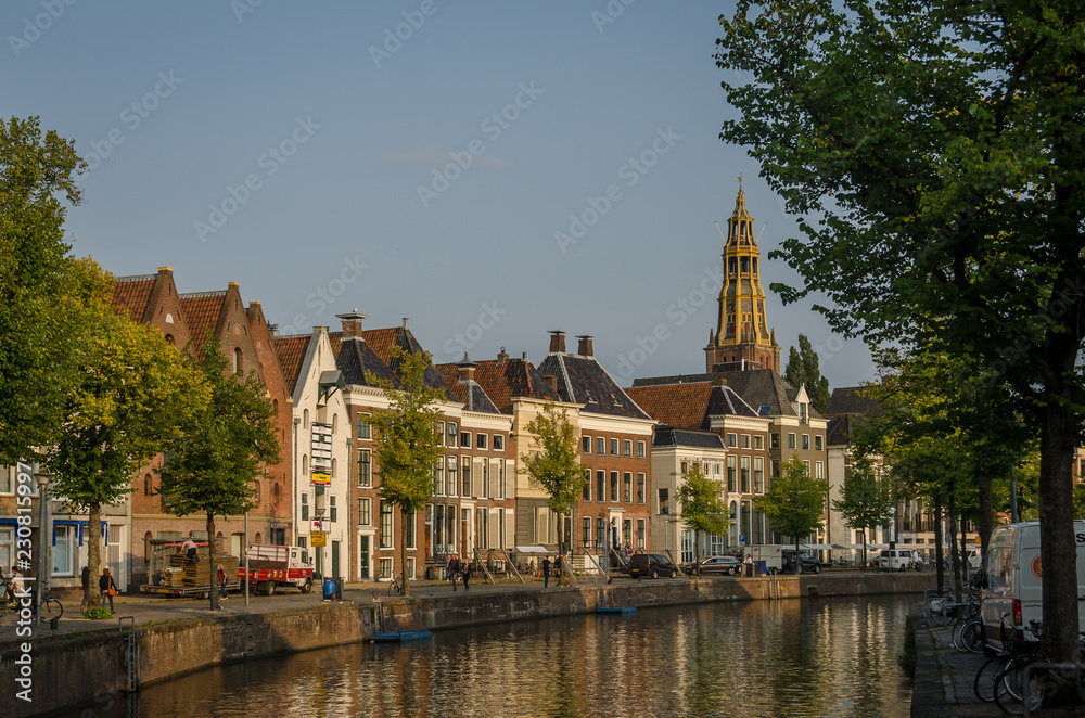 groningen, NETHERLANDS - August 28, 2018: Water and street in Groningen center. Church in the back