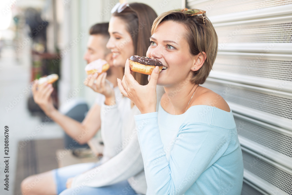 Beautiful young woman eating donut Beautiful young woman eating donut