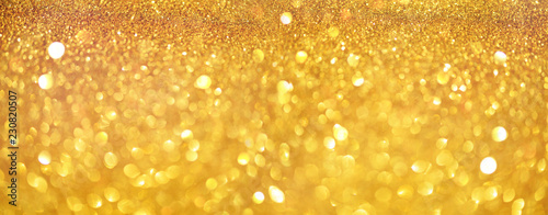 Gold glitter banner. Shiny abstract textured background with golden lights  bokeh. Christmas  new year concept with copy space for your greeting.