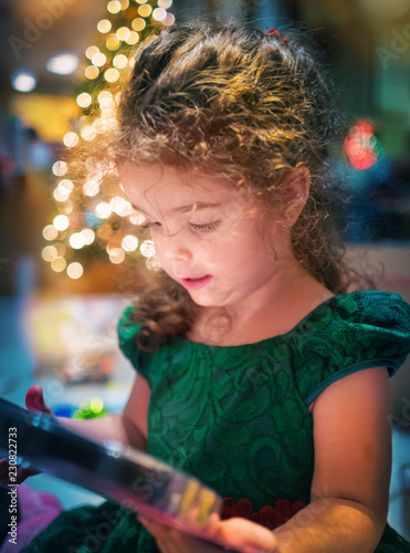 little girl opening Christmas gift