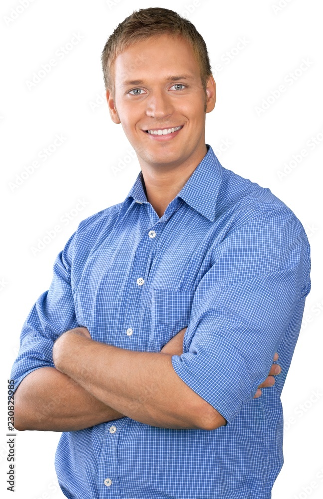Professional looking man with his arms crossed wearing a button Professional looking man with his arms crossed wearing a button