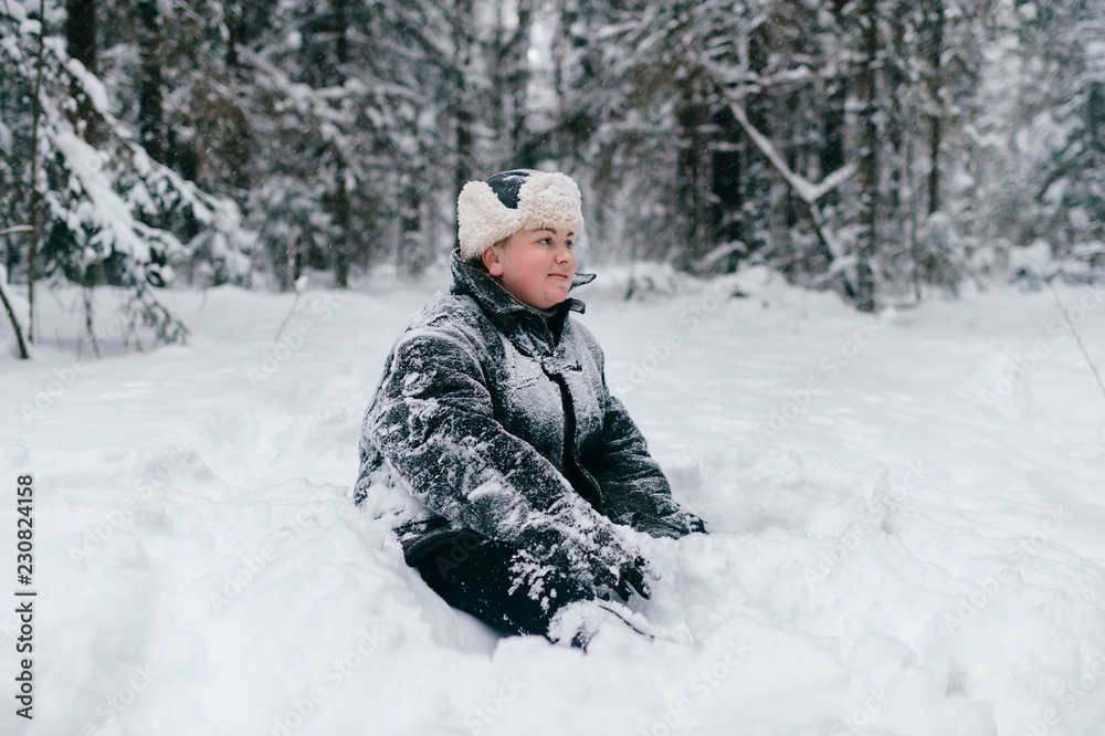 Country woman.  Strong independent adult female lifestyle winter portrait. Funny girl in padded jacket and hat fooling around with comic emotional face.  Brave powerful lady standing in snow outdoor.