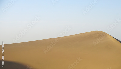 Desert sand dunes with blue sky, natural, beauty.