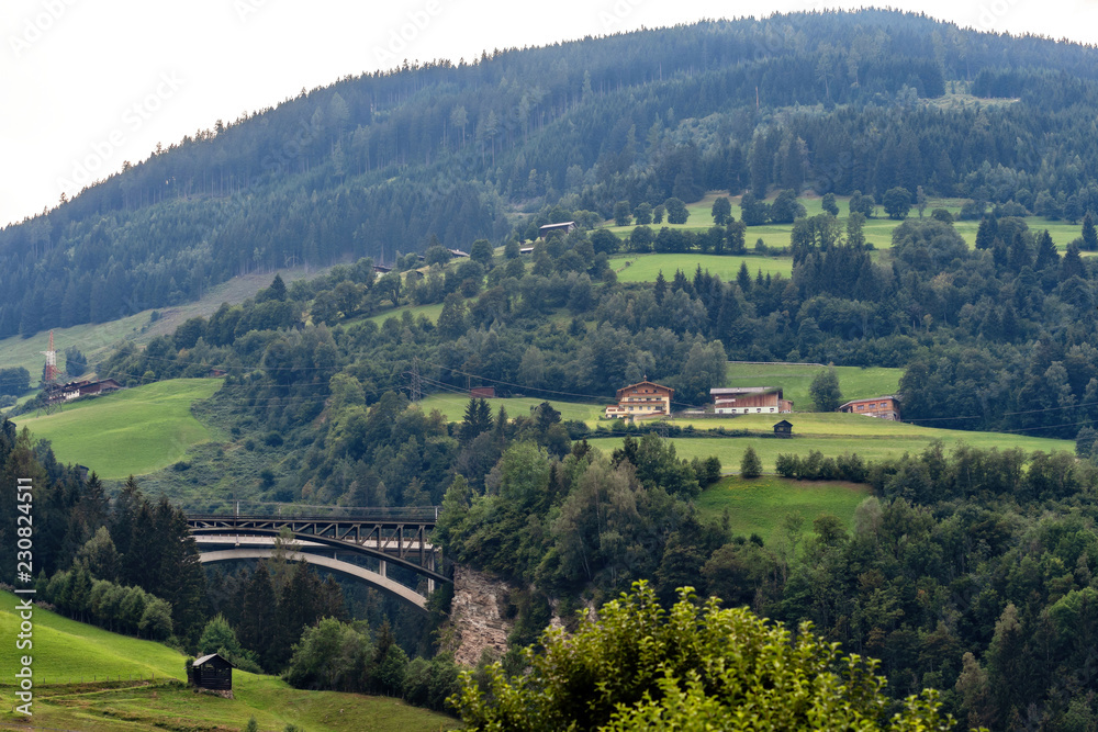 A picturesque Alpine landscape with an old railway bridge. Austria.