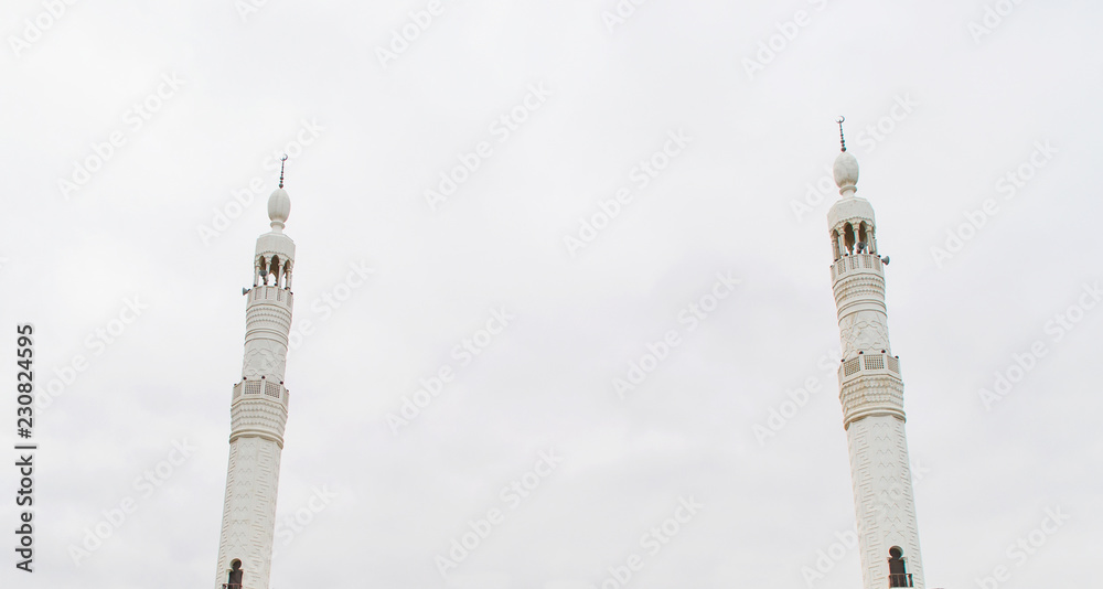 Two minarets  isolated on white background