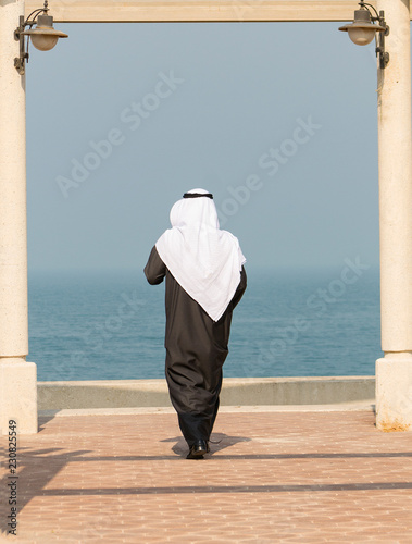 Seaside Frame With An Arab Man Wearing Traditional Dishdasha And Shemagh