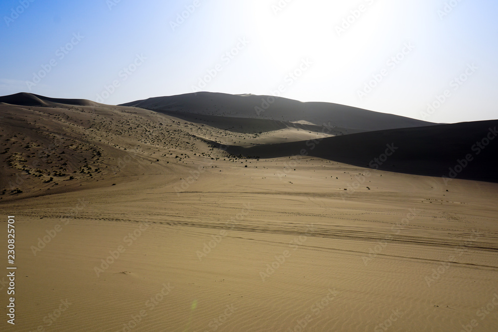 Desert sand dunes with blue sky background