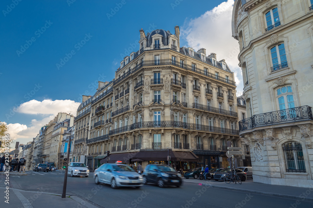 Streets of Paris, France. Blue sky, buildings and traffic.