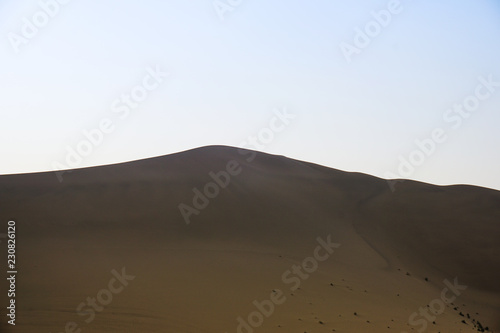 Desert with a blue sky. Beautiful curves of deserts