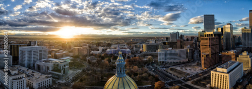 Obraz na płótnie Aerial/Drone panorama of the capital city of Denver, Colorado at sunset. The Rocky Mountains can be seen on the horizon w salonie