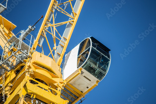 Dettail of a yellow crane and a deep clue sky