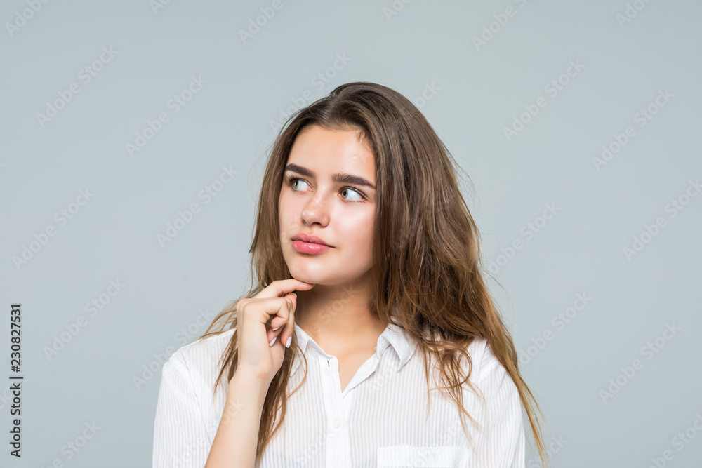 Young beautiful business woman hands on chin, thinking making choice, isolated on white background Young beautiful business woman hands on chin, thinking making choice, isolated on white background