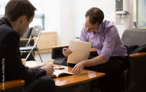 Business Meeting with People Reviewing Business Plans. Job Interview by Hiring Manager. Expert Businessmen. Career Legal Advisor is Reading and Presenting Documents to Client or Employee.