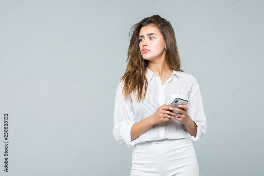 Business woman texting on her mobile phone isolated over white background Business woman texting on her mobile phone isolated over white background