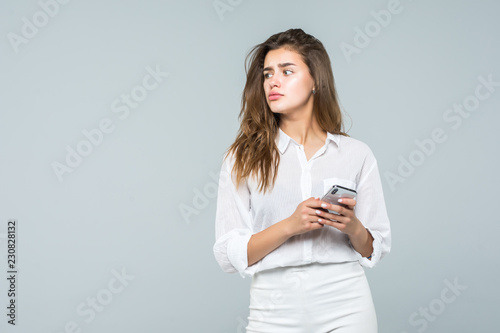 Business woman texting on her mobile phone isolated over white background