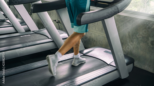 low section of man running on tradmill at gym 