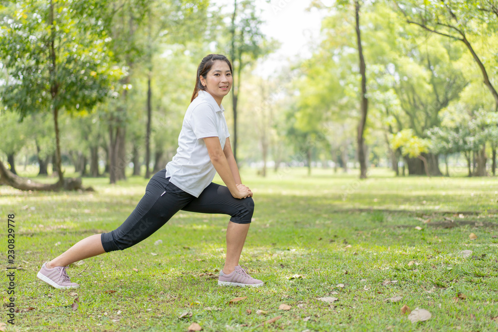 young asian woman jogging or exercise in green park .sporty woman concept. young asian woman jogging or exercise in green park .sporty woman concept.