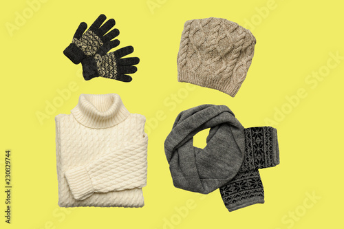 Set of sylish winter clothes on colour background with hat, mittens, sweater, scarf. flat lay, top view