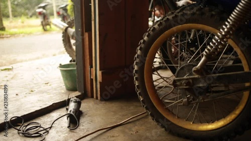 Man works in the background in mechanics garage