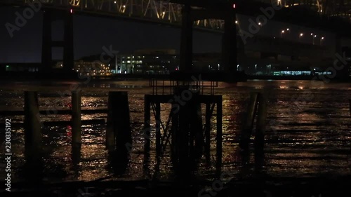 Pan up of I-10 bridge in New Orleans at night