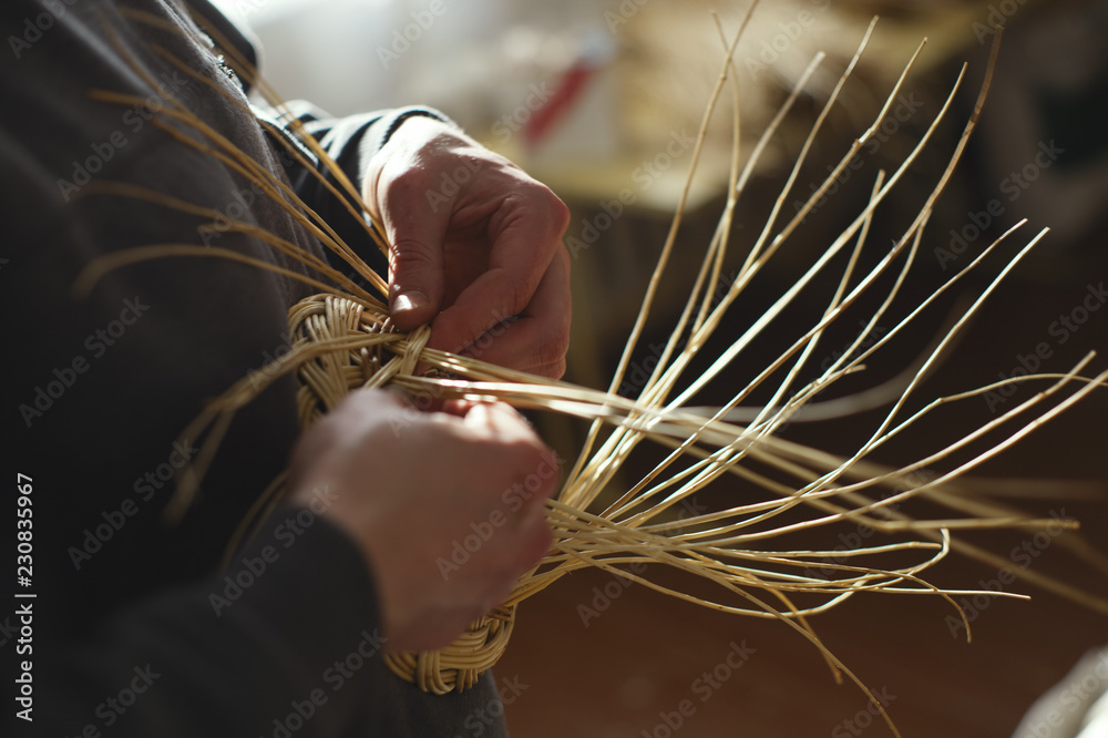 Basketwork from willow twigs in the workshop. - obrazy, fototapety, plakaty 