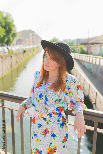 adult beautiful woman outdoor back light looking away thoughtful wearing hat - confidence, leisure, lighthearted concept photo