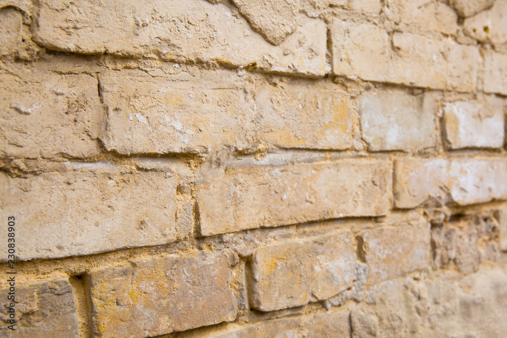 Part of old brick wall with crumbled plaster, close up Part of old brick wall with crumbled plaster, close up