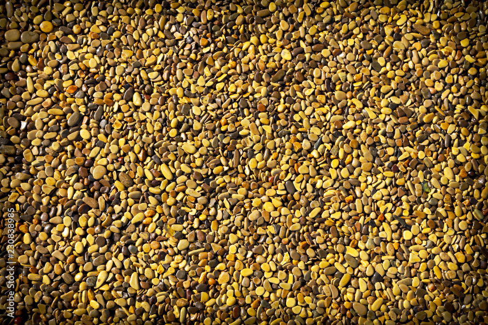 Small yellow stones on the road surface as background Small yellow stones on the road surface as background