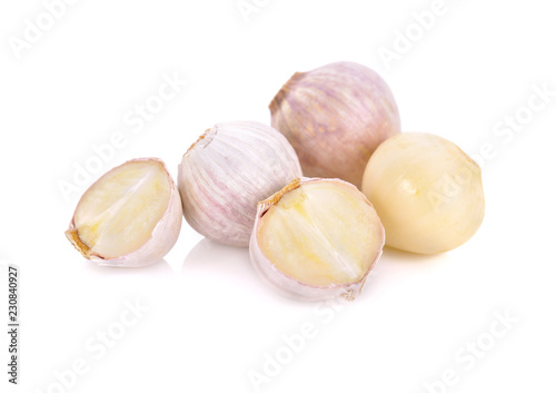 whole and cut garlic bulb on white background