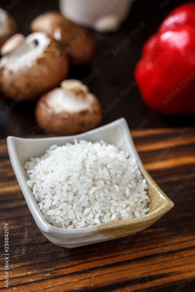 Ceramic bowl with the rice on wooden board. Ceramic bowl with the rice on wooden board.