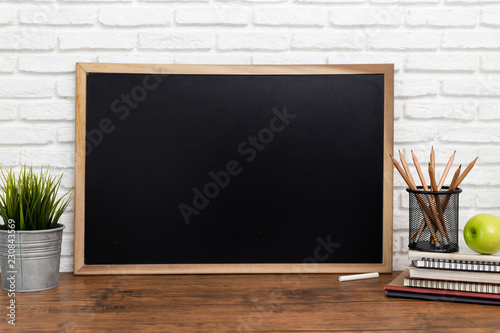 blackboard and a pencil on wooden background