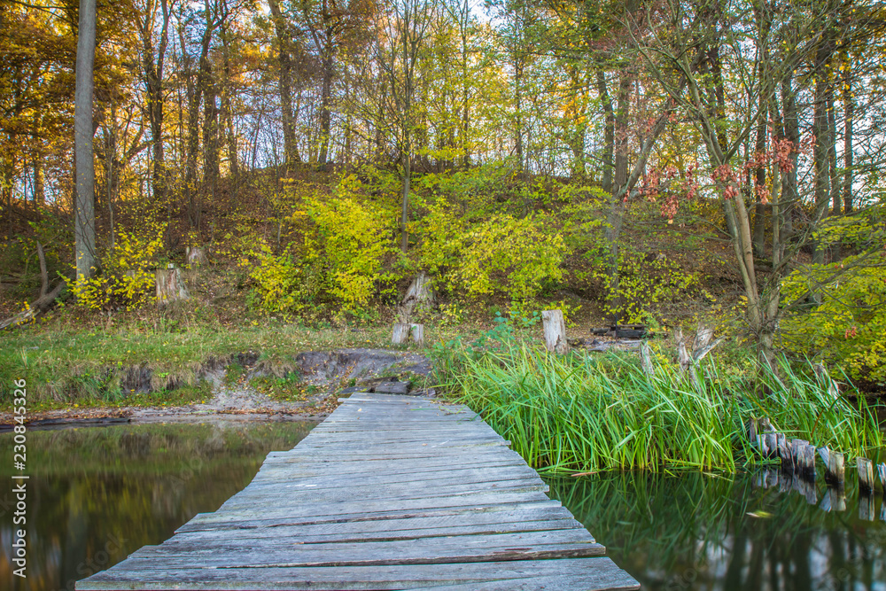 Lake in the autumn with an old wooden bridge - long exposure Lake in the autumn with an old wooden bridge - long exposure